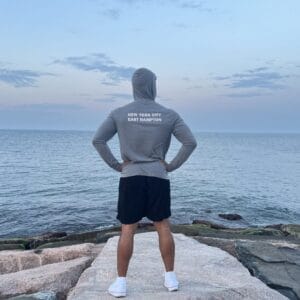 Phys eq trainer wearing Phys EQ gray hoodie in montauk