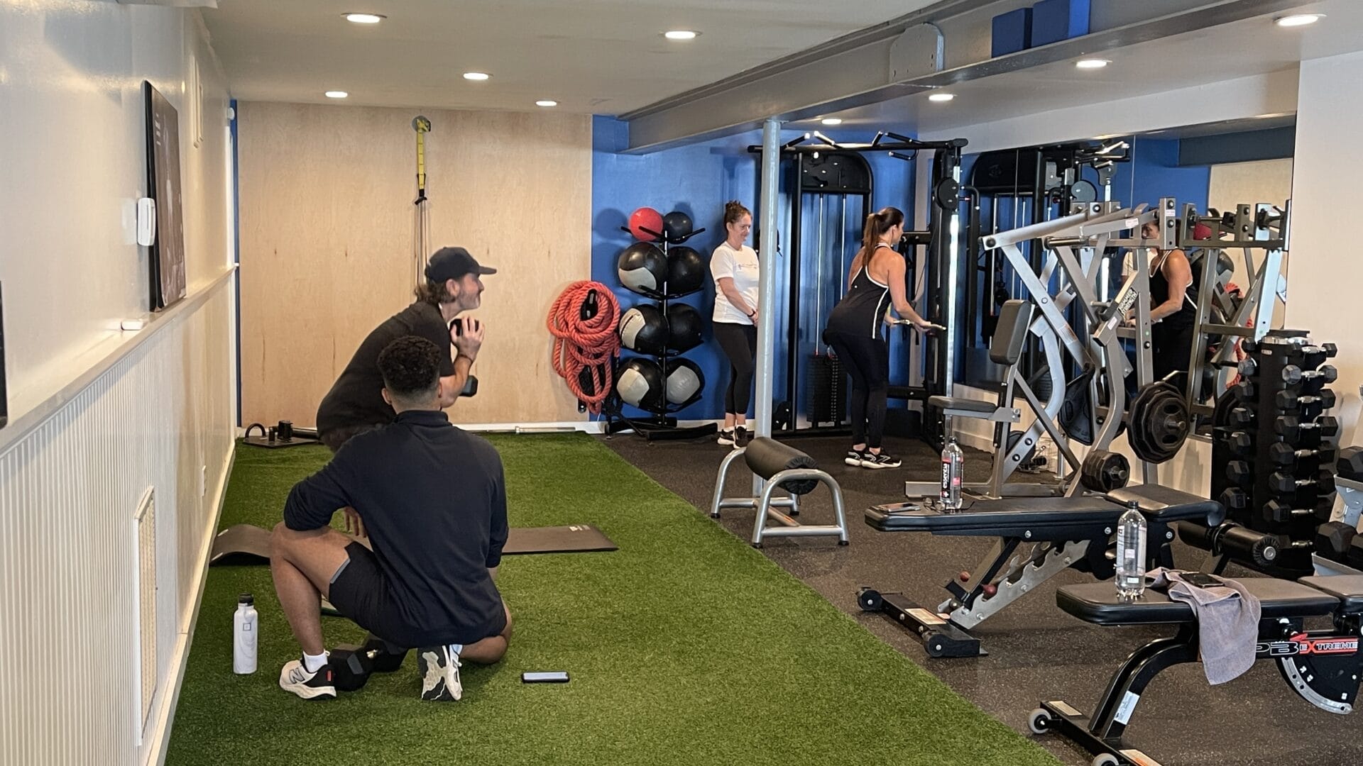 working out in the gym with personal trainers