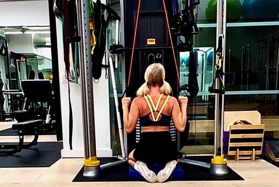 Physical Equilibrium personal trainer Kendra Madigan demonstrates a posture exercise in the personal training gym